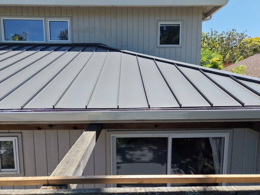 Charcoal standing seam metal roof on the lower level of a two-story Menlo Park home